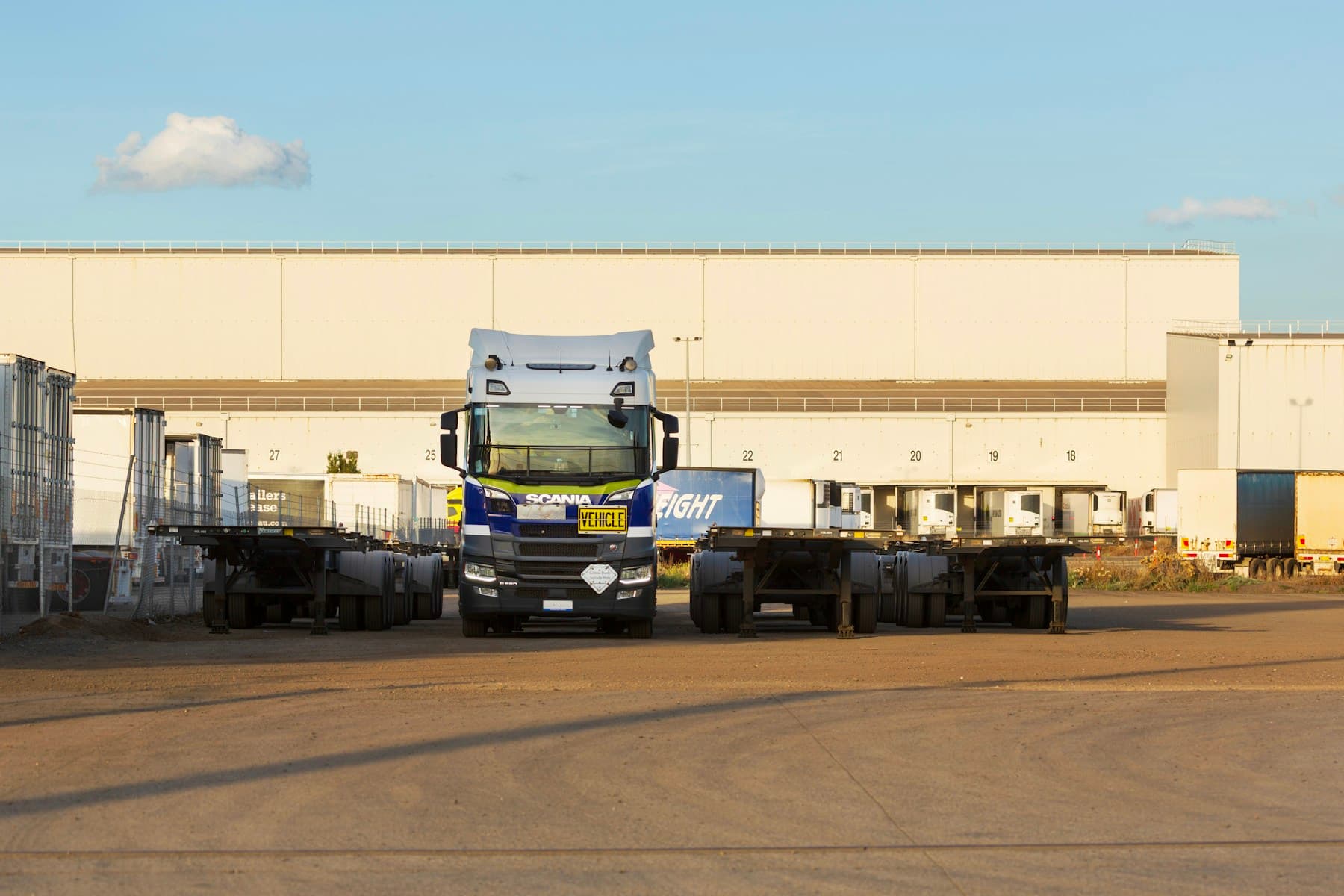 Semi-truck and trailers outside a distribution warehouse